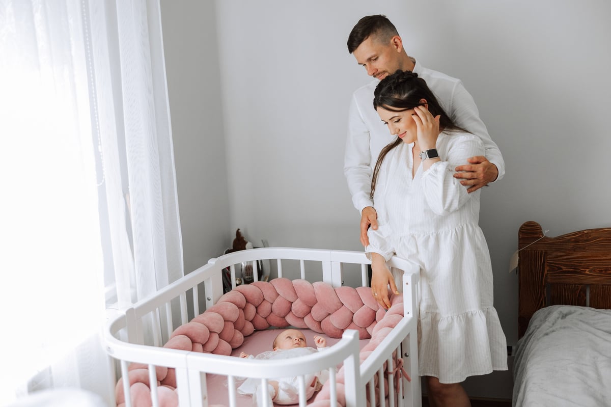 A sleeping newborn in a crib